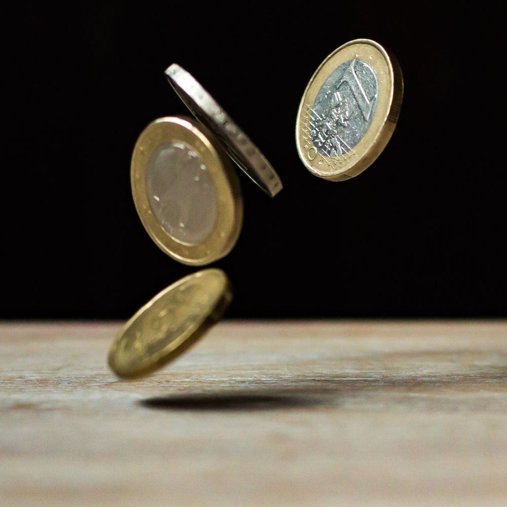 Koin di atas meja kayu untuk bonus deposit mingguan